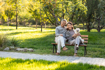 Cheerful senior couple with a cute dog