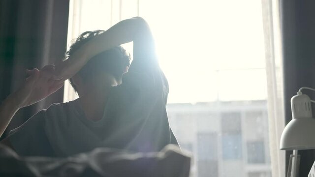 Beautiful women short hai Slowly Waking up in the Morning, Stretches and Gets Up from the Bed, Sun Shines on Her From the Big Window. Happy Young Girl Greets New Day in apartment 4k slow motion
