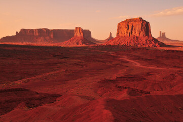 Naklejka premium Late afternoon sunlight bathing the buttes and mesas of Monument Valley Navajo Tribal Park, Utah - Arizona border, USA