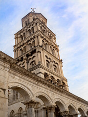 Fototapeta premium Ancient tower rises above arched city wall in Split, Croatia.