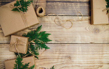 Boxes packed with kraft paper and natural twine on a wooden background.The concept of Christmas and New Year.