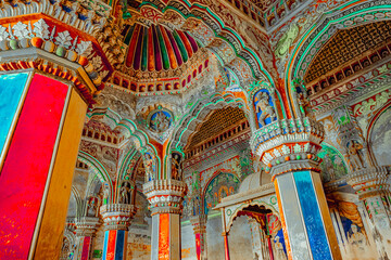 Thanjavur, Tamil Nadu, India - The high arches artworks and colorfully painted wall murals and ceilings of the ancient 17th-century durbar hall Maratha Palace in the town of Thanjavur