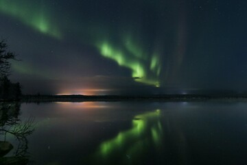 Aurora with reflection in the water over a lake