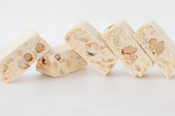 Traditional sliced nougat bar on white background.