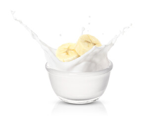 Banana with milk or yogurt splash isolated on white background.