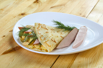 Pancake with potato and sausages