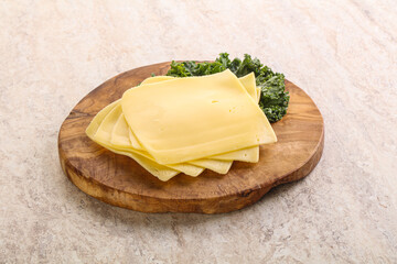 Sliced Gouda cheese over board