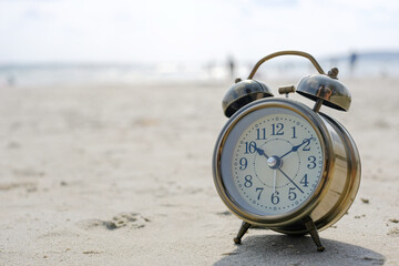 Morning of a new day, alarm clock  on the beach sunlight in morning. Health and travel concept.