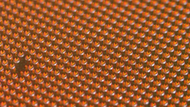 Soket pins on computer CPU in light of red color. Technology and development concept. Processor design, integrated circuit microprocessor