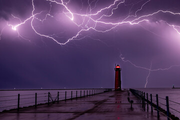 Thunderstorm with lightning over a lighthouse. 