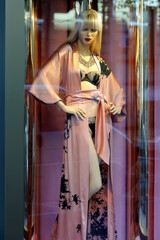 Mannequin in silk dressing gown in the shopfront window