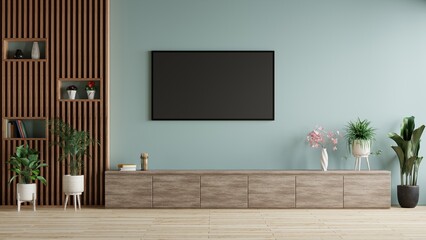 TV on blue wall in modern living room decorated with furniture and plant pots.3d rendering.