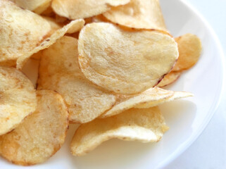Potato chips or crisps on a white plate.