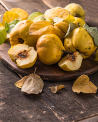 Quince fruits on a wooden background. Harvest of autumn fruits. Quince fruits