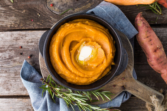 Spicy Mashed Sweet Potato Or Sweet Potato Puree With Rosemary In A Saucepan On A Table.  Top View From Above.