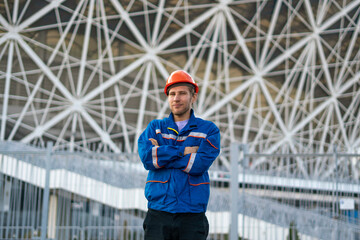young male worker of builder in blue uniform portrait