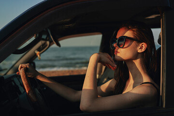 Fototapeta na wymiar cheerful woman in sunglasses driving a car trip travel