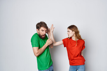 Fototapeta premium man and woman multicolored t-shirts communication quarrel light background
