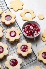 Linzer Christmas or New Year cookies filled with jam and dusted with sugar on grey background. Traditional Austrian Christmas cookies. Shortbread cookies. Homemade sweet present.