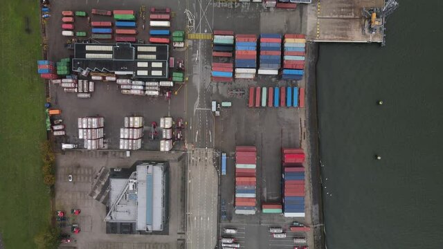 Container and silos in the Port of Rotterdam heavy industry and transportation along the Oude Maas Petroleum harbour aerial drone overview.
