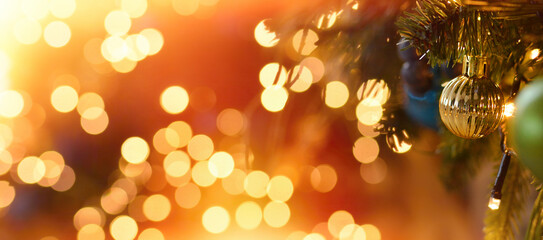 Christmas balls hanging on the background of beautiful golden bokeh.Christmas mood . Happy New Year and Merry Christmas. Copy space
