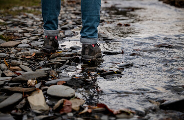 Closeup of man leg walking along river, in Tejera Negra, Cantalojas, Guadalajara, Spain