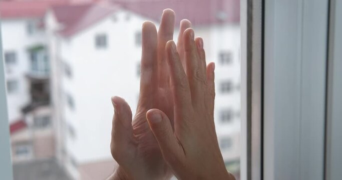 Man And Woman Hands On Window. A View Of Woman And Man Hands Touching The Window In Separation.