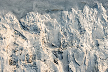 Fototapeta premium Wet sand on the river bank close up top view