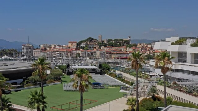 Cannes France Aerial v34 cinematic low level flying from palais des festivals convention center next to vieux port toward battlement watchtower of chateau de la castre - July 2021