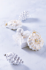 Christmas ornaments and small present in white