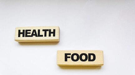 The word HEALTHY FOOD made from wooden blocks on a white background. Healthy food concept