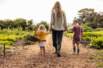 Young mother going harvesting with her two kids