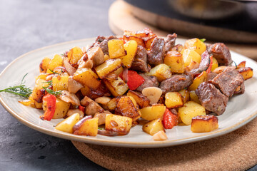 Roast with potato pieces of meat and mushrooms, simple homemade food.