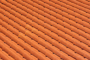 Obraz na płótnie Canvas Close-up of new clay ceramic roof tiles on a building