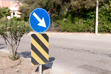 traffic safety signs on city street road. direction movement sign outdoor. danger warning symbol on...