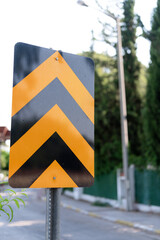 traffic safety signs on city street road. direction movement sign outdoor. danger warning symbol on...