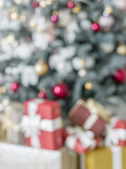 Red gift box and decorated New Year Tree on the background.