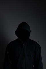 Naklejka na ściany i meble man wearing black hoodie on black background