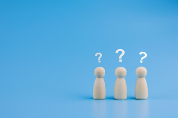 Human wooden block with question mark icon on blue background. concept of doubt Questioning and troubleshooting. with copy space