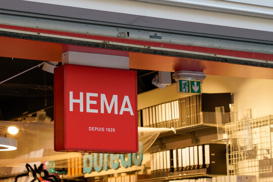 hema shop sign text and brand logo red store front boutique in street