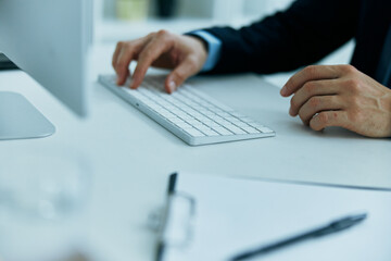 Fototapeta premium keyboard on desktop hands typing close up
