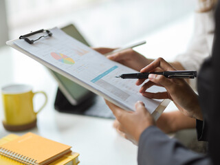 Cropped image of female manager looking at financial report