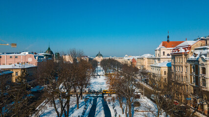Fototapeta na wymiar aerial view of city square in front of opera building in Lviv, sunny winter day
