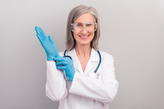 Photo of good mood happy mature lady doctor wear white coat spectacles smiling ready operation isolated grey color background