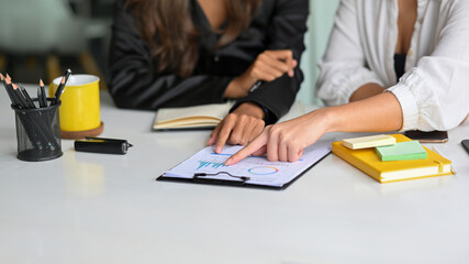 Two female voting the best plans for new campaign