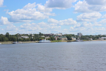 View from a motor ship sailing along the Volga River to the city of Kostroma standing on the shore