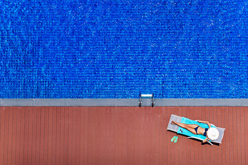Woman near swimming pool.