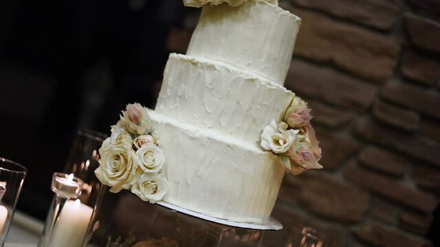 Elegant Three Tier Wedding Cake With Decorated With Flowers. - close up