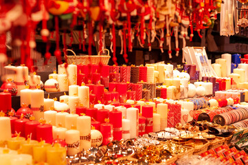 Stands of sale of the Christmas market of Strasbourg, France.A stand selling very colorful and festive items. All these multicolored candles shine under the light of the lamps.
