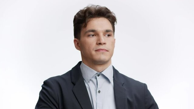 Exhausting office work. Young manager unbuttoning his suit collar and deep breathing, looking sadly at cameran
